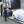 A person using a TRC Ultra H2O Foam Cannon to spray soap onto a blue car.