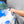A person spraying water onto a blue car using a TRC Ultra H2O Spray Gun.