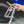 A person holding a TRC Ultra H2O Spray Gun connected to a pressure washer hose.