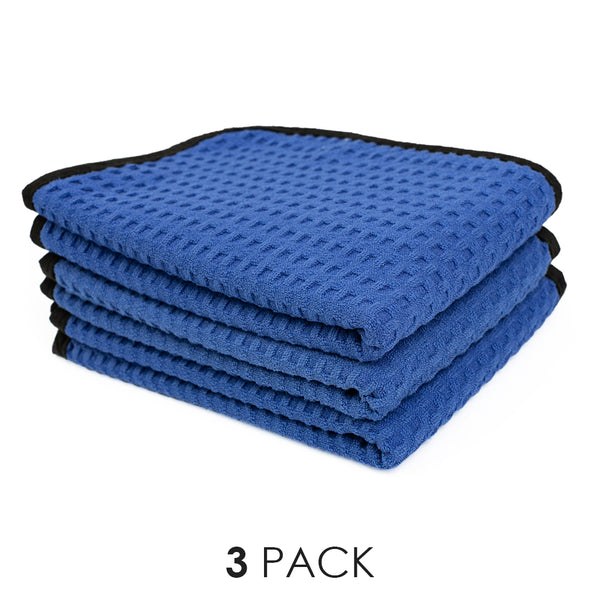 A picture of the 3 pack of Dry Me A River waffle weave microfiber towels from The Rag Company in royal blue with a black border