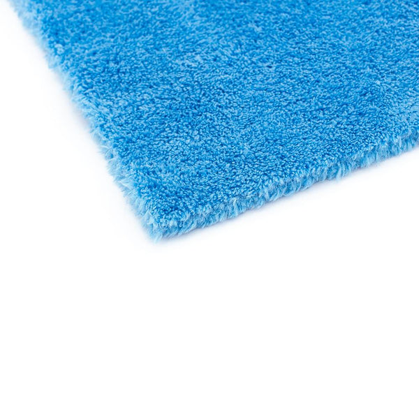 The corner of a blue 16x16 Eagle Edgeless Towel from The Rag Company. Having no edges or tags prevents scratching paint or glass.