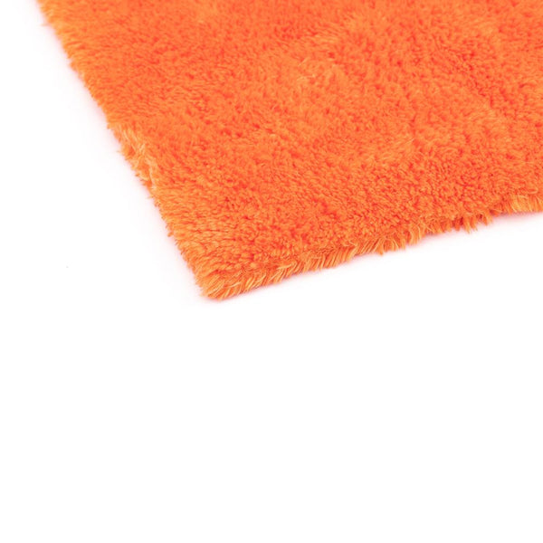 The corner of an Orange 16x16 Eagle Edgeless Towel from The Rag Company. Having no edges or tags prevents scratching paint or glass.