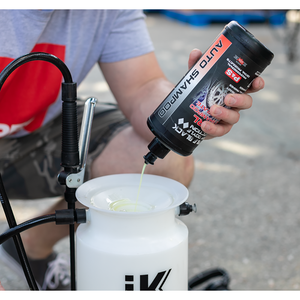 A closeup of a person pouring P & S Pearl into an IK Sprayer.