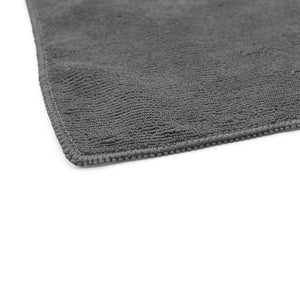 The corner of a grey towel on a white background.