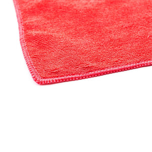 The corner of a red towel on a white background.