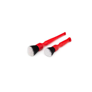 A long and short red Synthetic Detailing Brush on a white background.