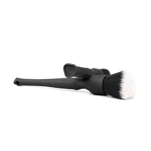 Two black Detail Factory Synthetic Brushes crossing on a white background.