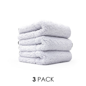 3 white towels stacked on top of eachother