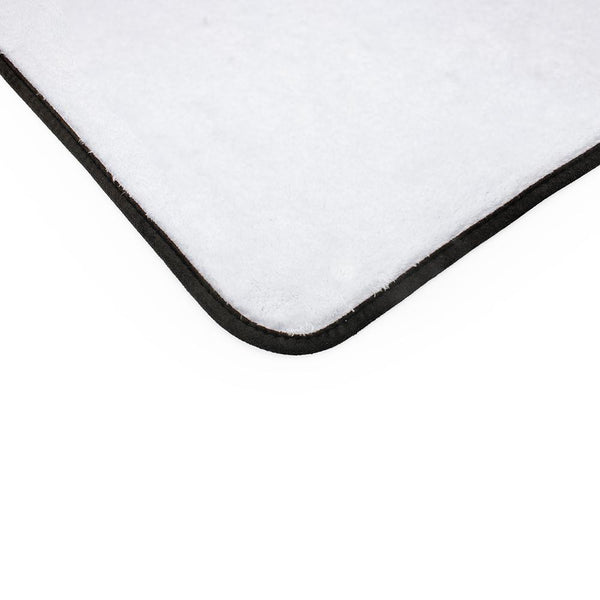 Corner of a white microfiber towel with a black border