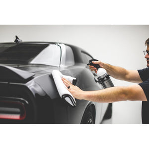 Koch Chemie Quick Finish 1L bottle spraying product on a car. 