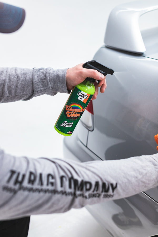 A person spraying P and S Shamrock Shine on a grey car.