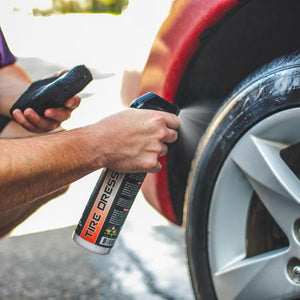 A closeup of a person spraying P & S Shine All on the tire of a car.