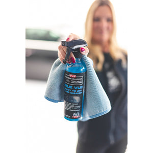A closeup of a person holding P & S True Vue and a blue towel up to the camera.