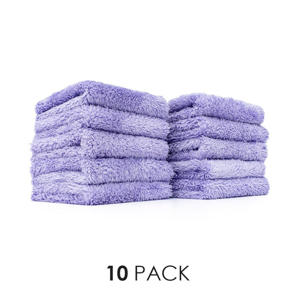 Two stacks of five purple microfiber towels on a white background
