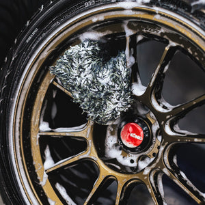 Wheel Mitt being used to clean a tire wheel